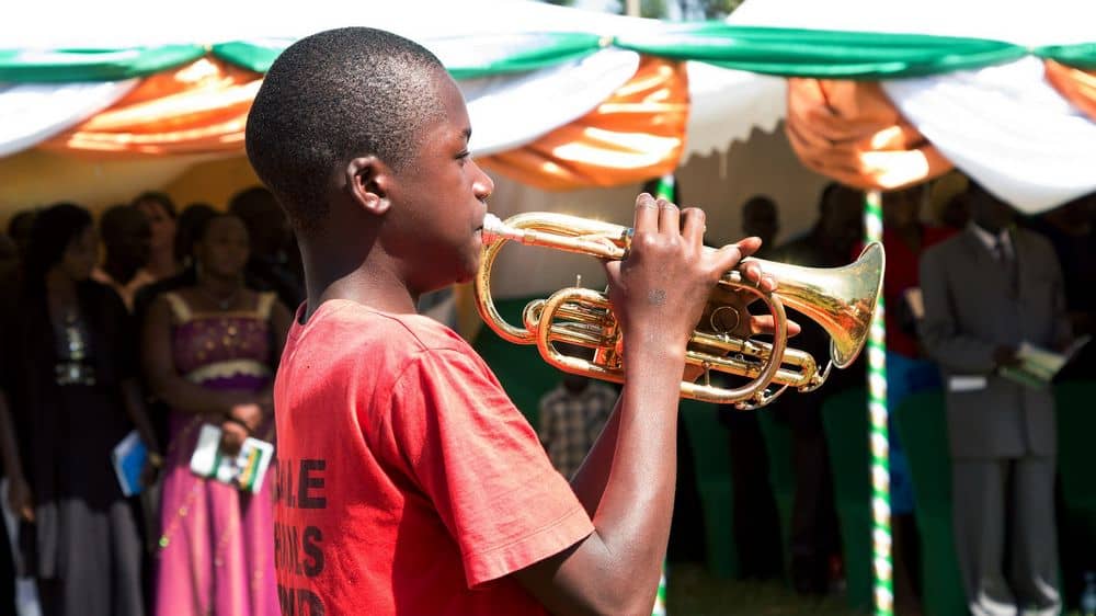 Young boy learning to play trumpet