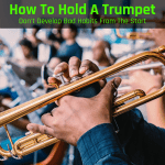 Holding a trumpet
