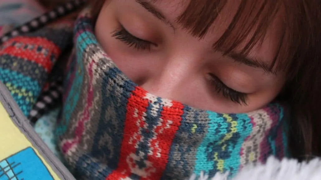 Sick woman keeping throat warm to protect voice