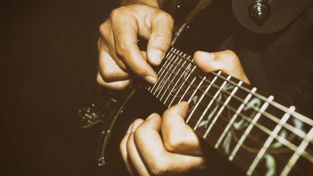 Guitarist playing on fretboard