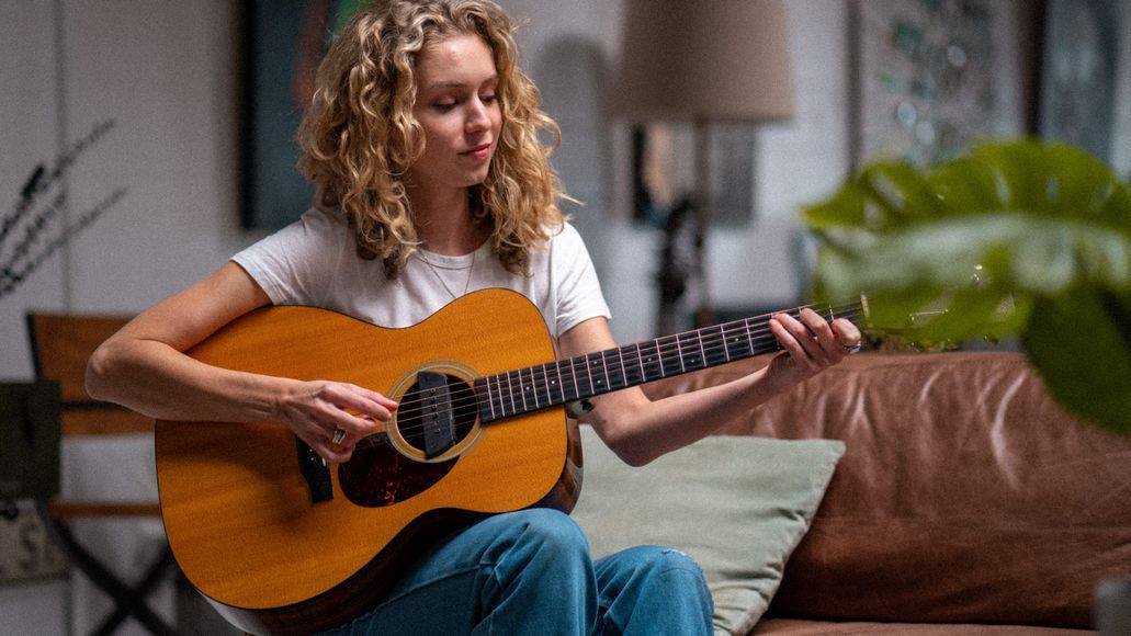 Woman practicing a song on the guitar