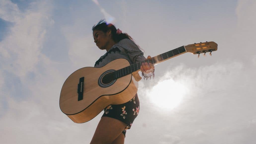 Girl carrying classical guitar