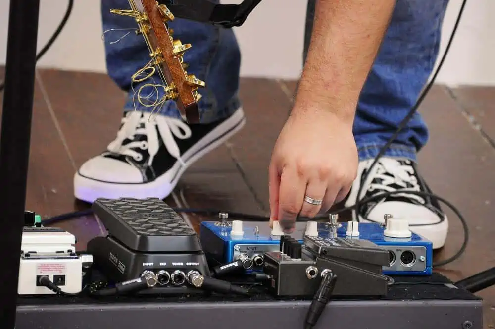guitarist using an effect pedal