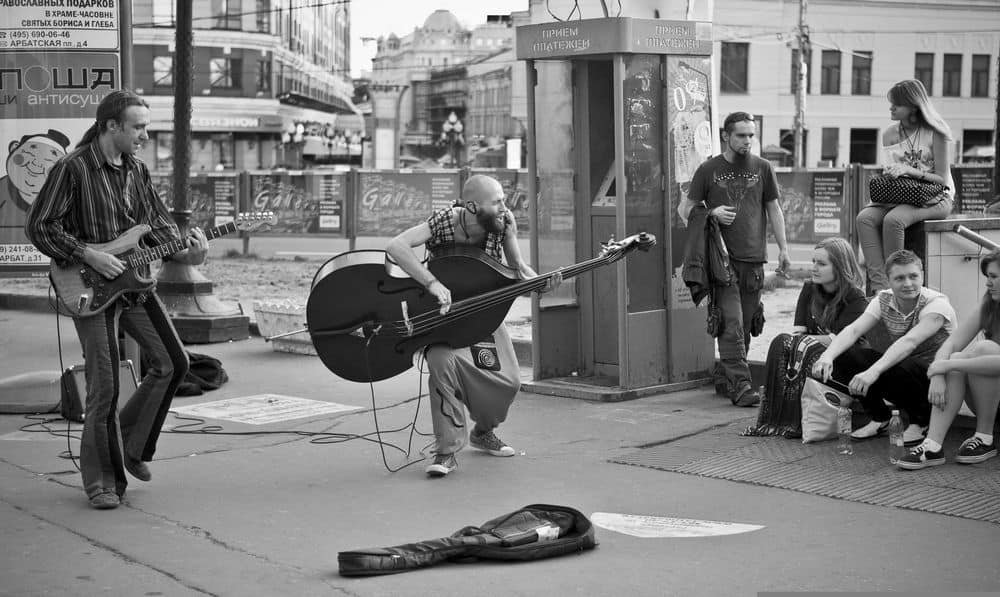 man playing upright bass like guitar